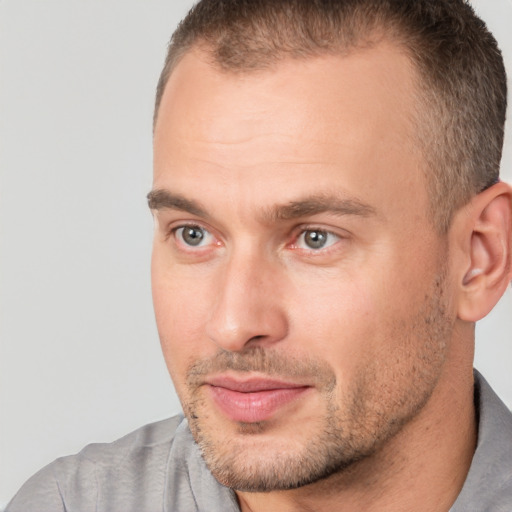 Joyful white adult male with short  brown hair and brown eyes