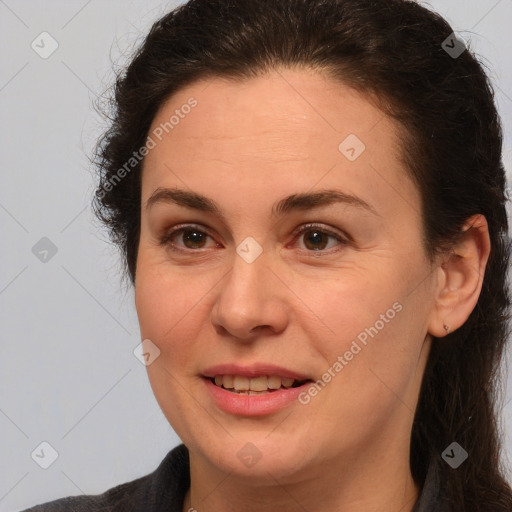 Joyful white adult female with medium  brown hair and brown eyes