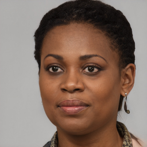 Joyful black young-adult female with medium  brown hair and brown eyes