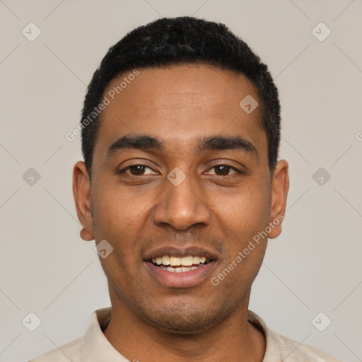 Joyful black young-adult male with short  black hair and brown eyes