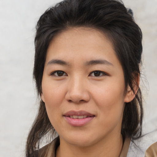 Joyful asian young-adult female with medium  brown hair and brown eyes