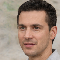 Joyful white adult male with short  brown hair and brown eyes