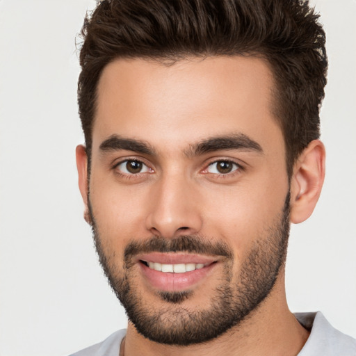 Joyful white young-adult male with short  brown hair and brown eyes