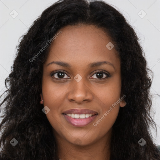 Joyful black young-adult female with long  brown hair and brown eyes