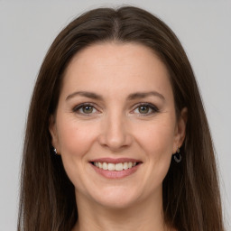 Joyful white young-adult female with long  brown hair and grey eyes