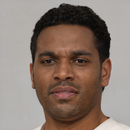 Neutral black young-adult male with short  black hair and brown eyes