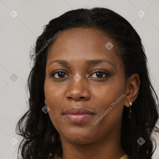 Joyful black young-adult female with long  black hair and brown eyes