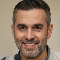 Joyful white adult male with short  brown hair and brown eyes