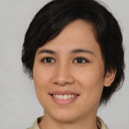 Joyful asian young-adult female with medium  brown hair and brown eyes