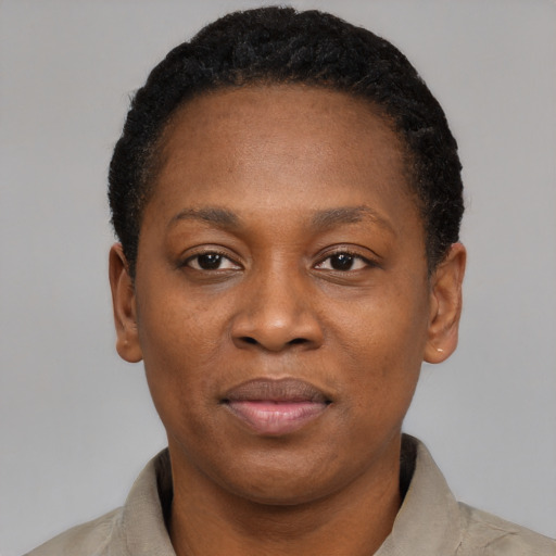 Joyful black adult female with short  black hair and brown eyes