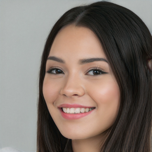 Joyful white young-adult female with long  black hair and brown eyes