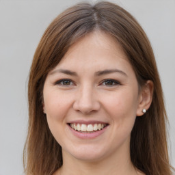 Joyful white young-adult female with long  brown hair and brown eyes