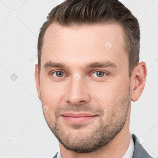 Joyful white young-adult male with short  brown hair and brown eyes