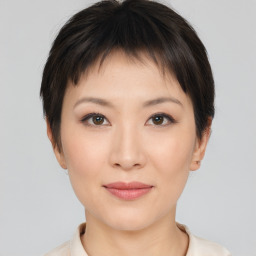 Joyful asian young-adult female with short  brown hair and brown eyes