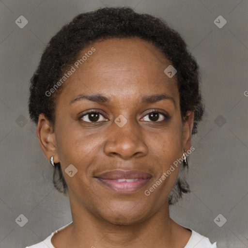 Joyful black adult female with short  brown hair and brown eyes