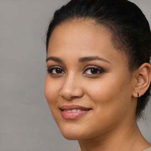 Joyful latino young-adult female with medium  brown hair and brown eyes