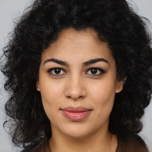 Joyful latino young-adult female with long  brown hair and brown eyes