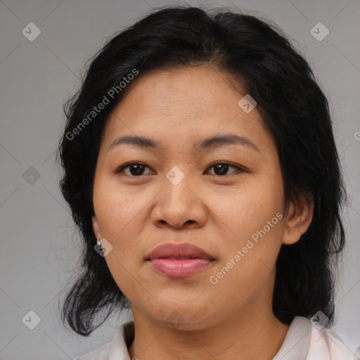 Joyful asian adult female with medium  brown hair and brown eyes