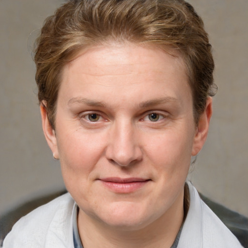 Joyful white adult female with short  brown hair and grey eyes