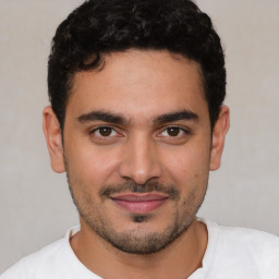Joyful white young-adult male with short  black hair and brown eyes