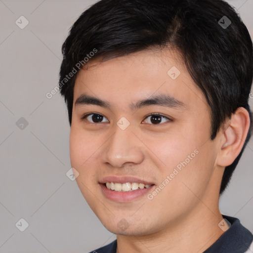 Joyful white young-adult male with short  black hair and brown eyes