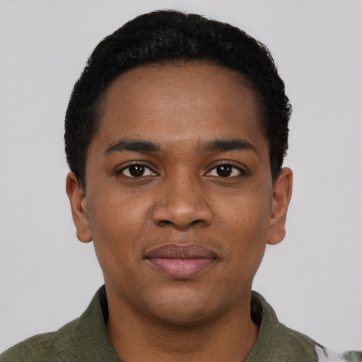 Joyful black young-adult male with short  black hair and brown eyes