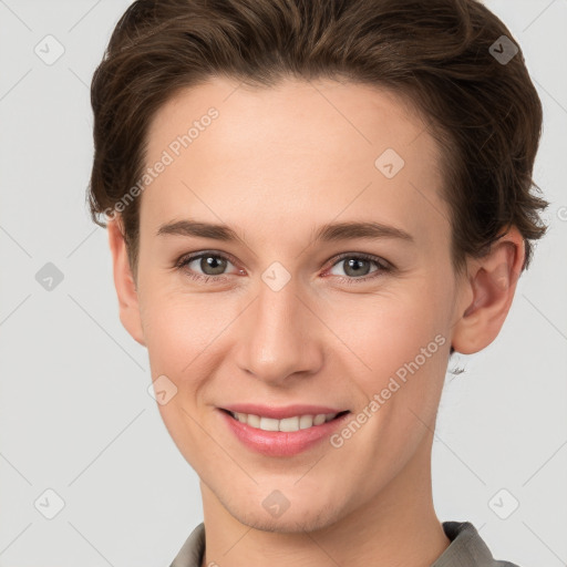 Joyful white young-adult female with short  brown hair and grey eyes