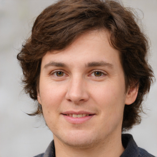 Joyful white young-adult male with medium  brown hair and brown eyes