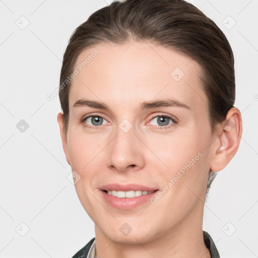 Joyful white young-adult female with short  brown hair and grey eyes