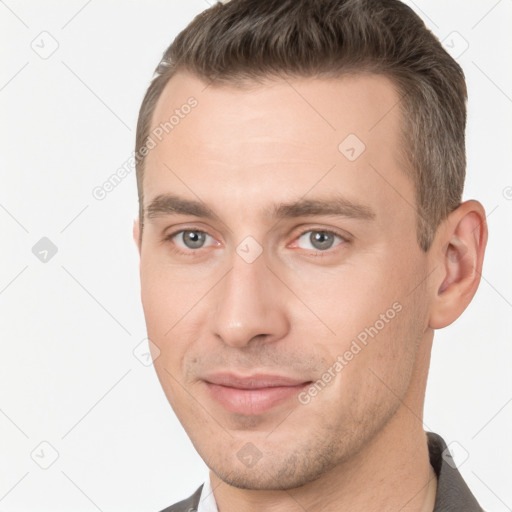 Joyful white young-adult male with short  brown hair and brown eyes