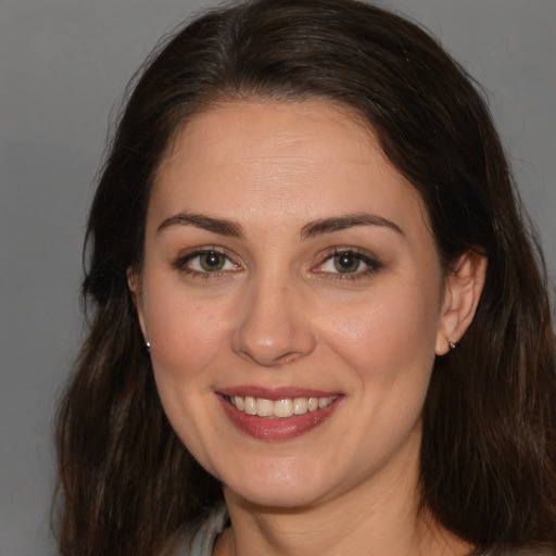 Joyful white young-adult female with medium  brown hair and brown eyes