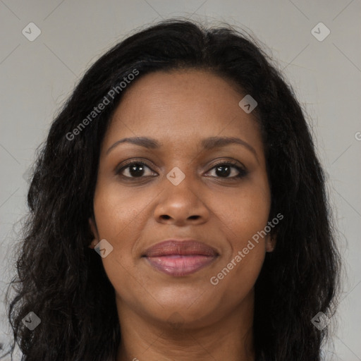 Joyful black young-adult female with long  brown hair and brown eyes