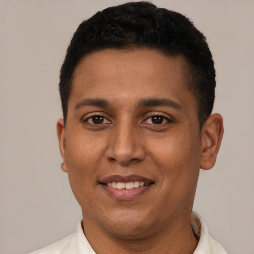 Joyful latino young-adult male with short  black hair and brown eyes