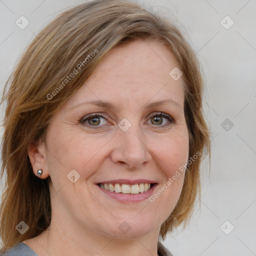 Joyful white adult female with medium  brown hair and blue eyes