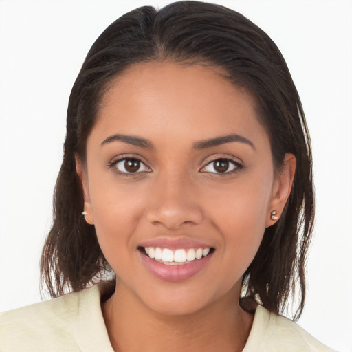 Joyful latino young-adult female with long  brown hair and brown eyes