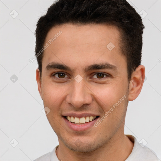 Joyful white young-adult male with short  brown hair and brown eyes