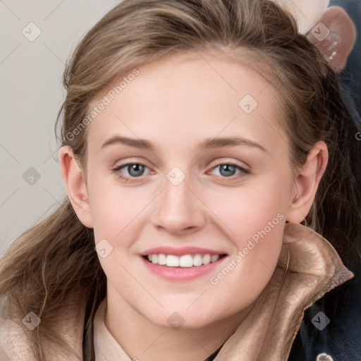 Joyful white young-adult female with long  brown hair and blue eyes