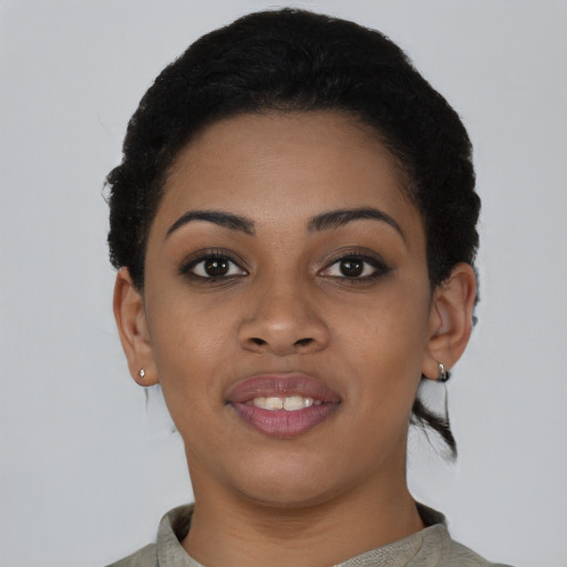 Joyful black young-adult female with short  black hair and brown eyes
