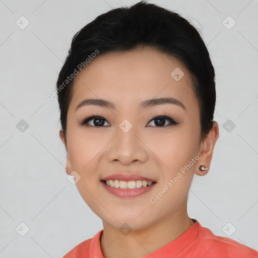 Joyful asian young-adult female with short  black hair and brown eyes