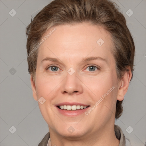 Joyful white adult female with short  brown hair and grey eyes