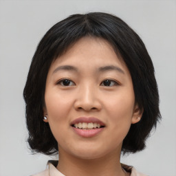 Joyful asian young-adult female with medium  black hair and brown eyes