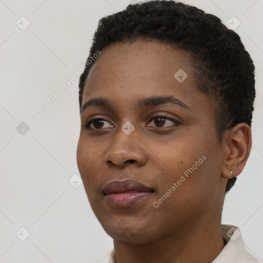 Joyful black young-adult female with short  black hair and brown eyes