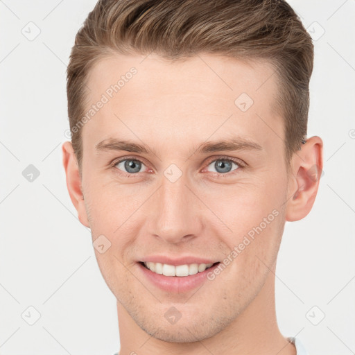 Joyful white young-adult male with short  brown hair and grey eyes