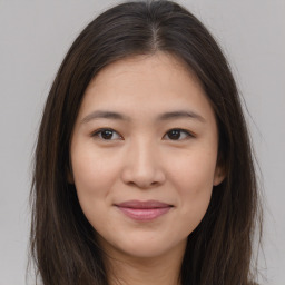 Joyful asian young-adult female with long  brown hair and brown eyes