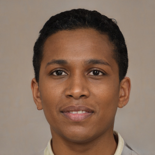 Joyful black young-adult male with short  black hair and brown eyes