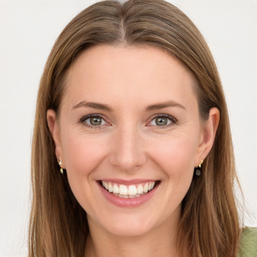 Joyful white young-adult female with long  brown hair and green eyes