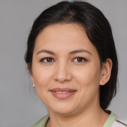 Joyful asian adult female with medium  brown hair and brown eyes