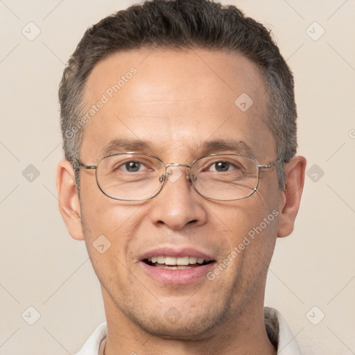 Joyful white adult male with short  brown hair and brown eyes