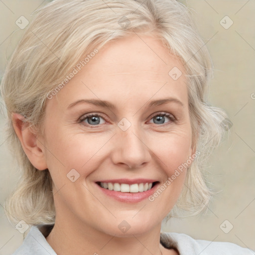 Joyful white adult female with medium  blond hair and blue eyes