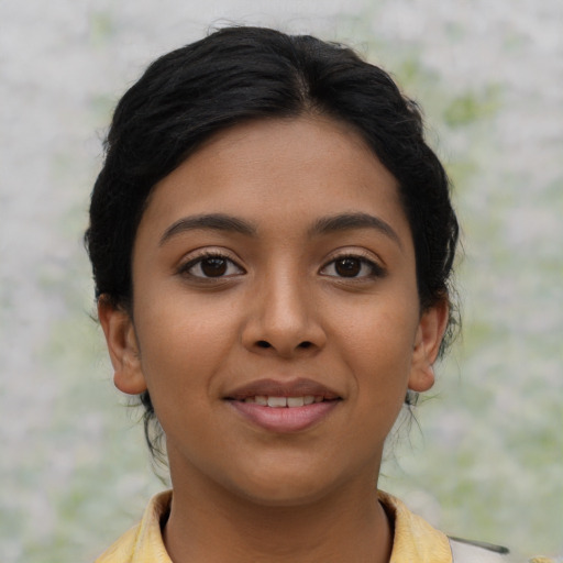 Joyful latino young-adult female with short  brown hair and brown eyes